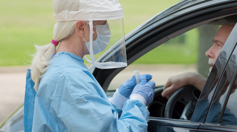 Nurse beside car